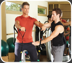 Personal Trainer and Young Man using Powerplate Machine for Resistance Training